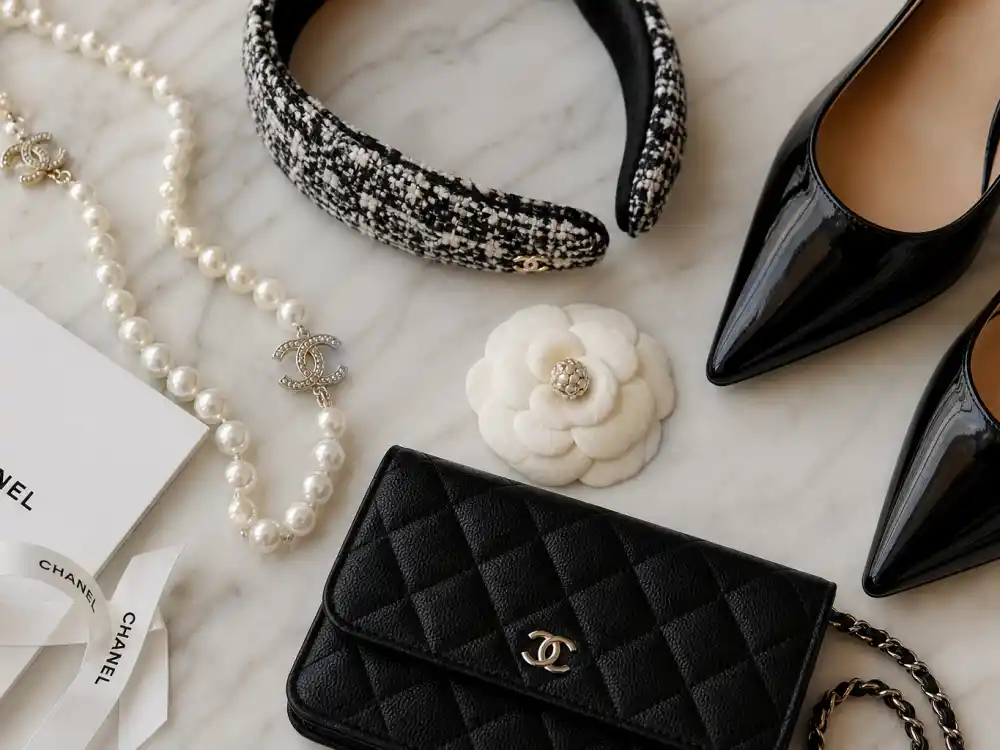 Pearl necklace tweed headband quilted clutch and camellia brooch flat lay capturing accessory finishing rules for Chanel celebrity red carpet looks every awards season