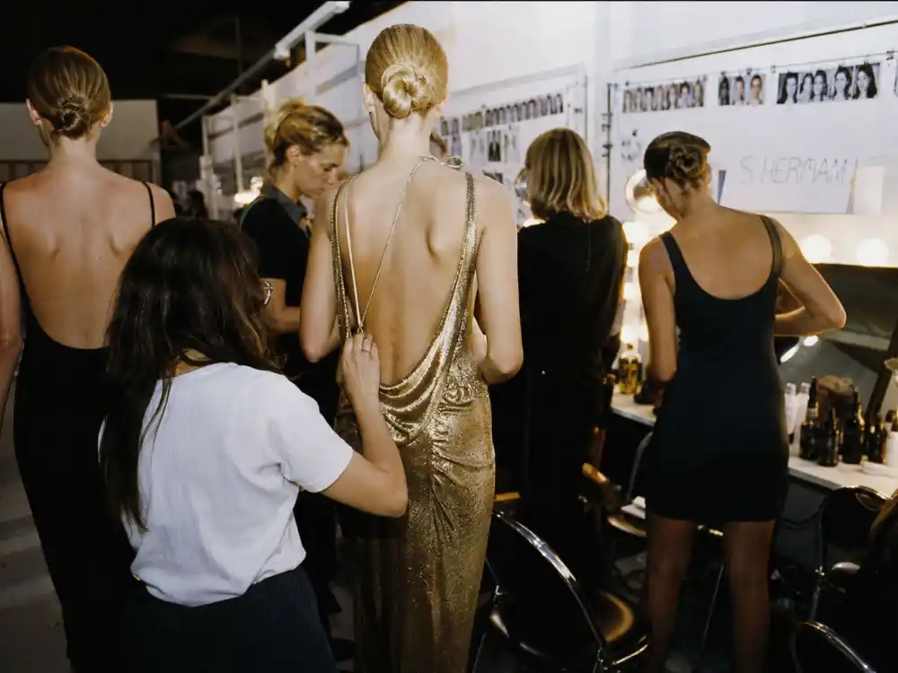 A 1990s fashion runway backstage scene for Claudia Schiffer supermodel breakthrough era