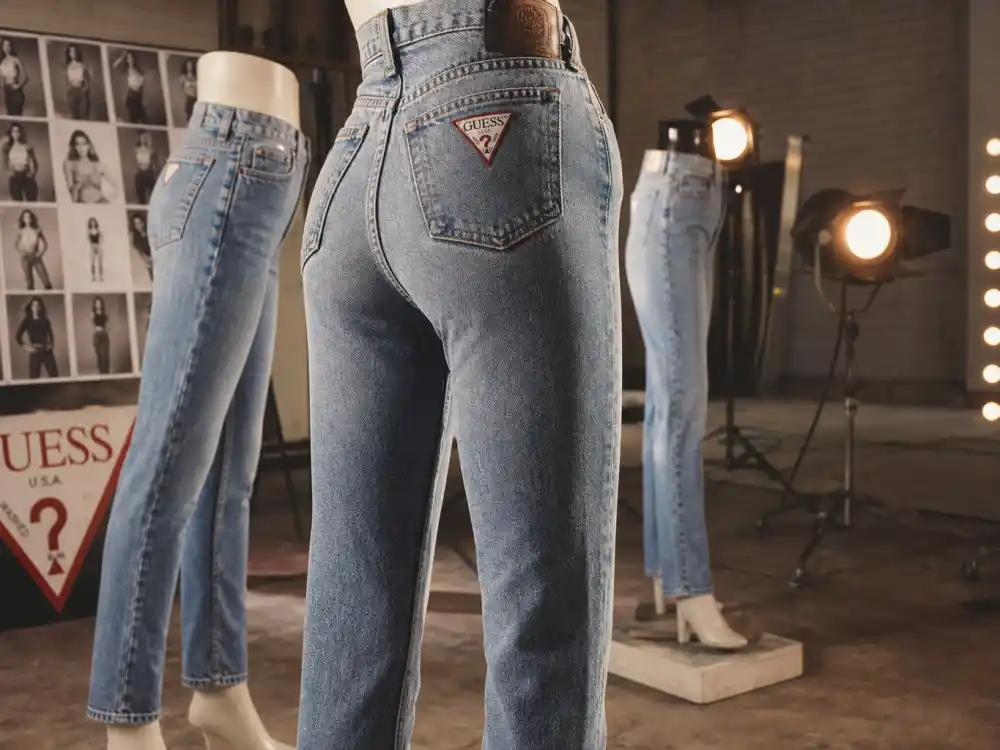Vintage denim fashion studio evoking Claudia Schiffer iconic Guess Jeans campaign years