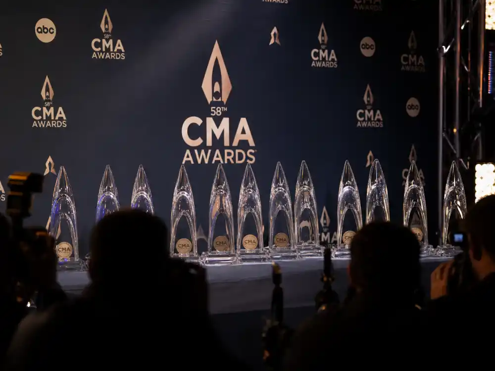 CMA Awards press wall with glass trophies before ceremony that may rewrite the most CMA awards won by an artist leaderboard