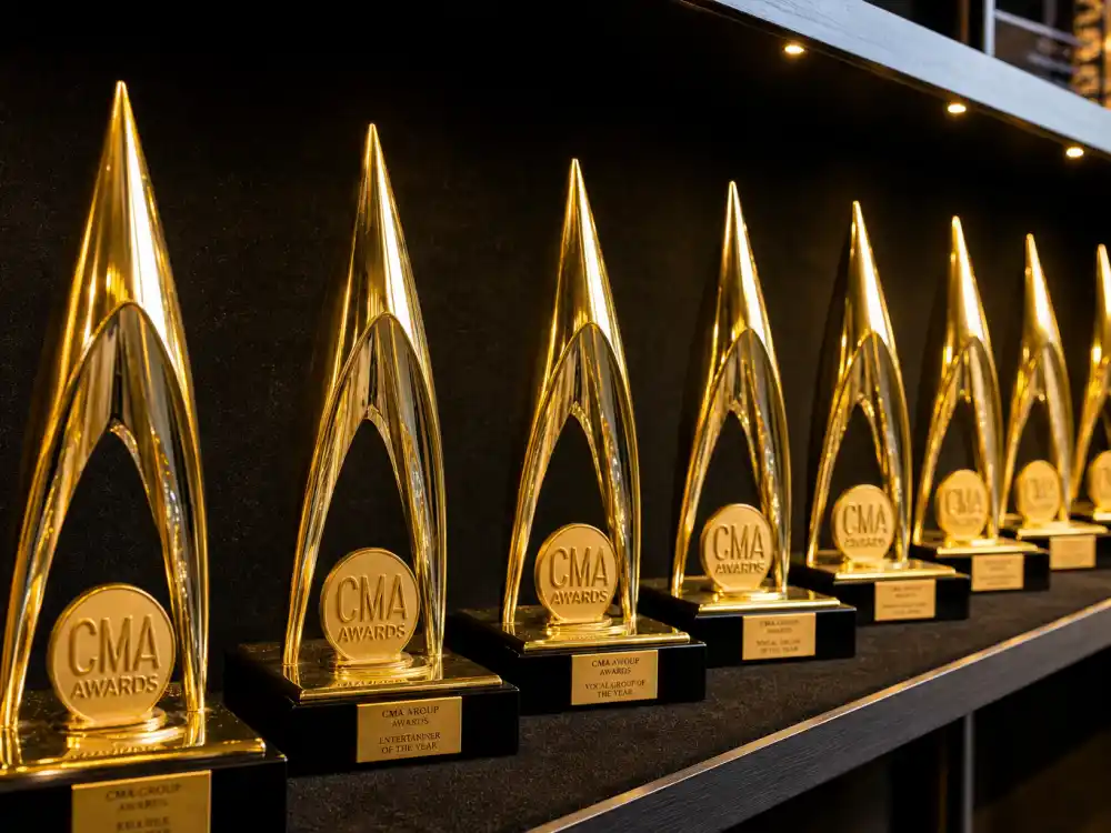 Row of golden country music award statuettes representing decades of CMA Entertainer of the Year winners by year from Eddy Arnold to Lainey Wilson