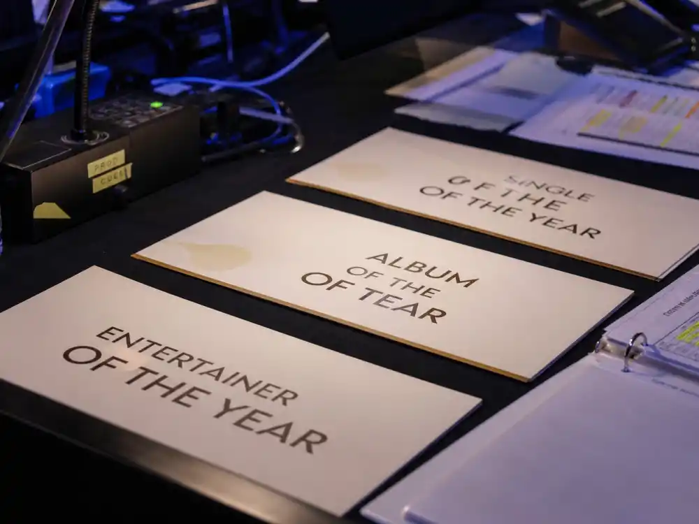 Country music award category nomination cards for CMA vs ACM Awards difference — Entertainer and Album of the Year fields compared