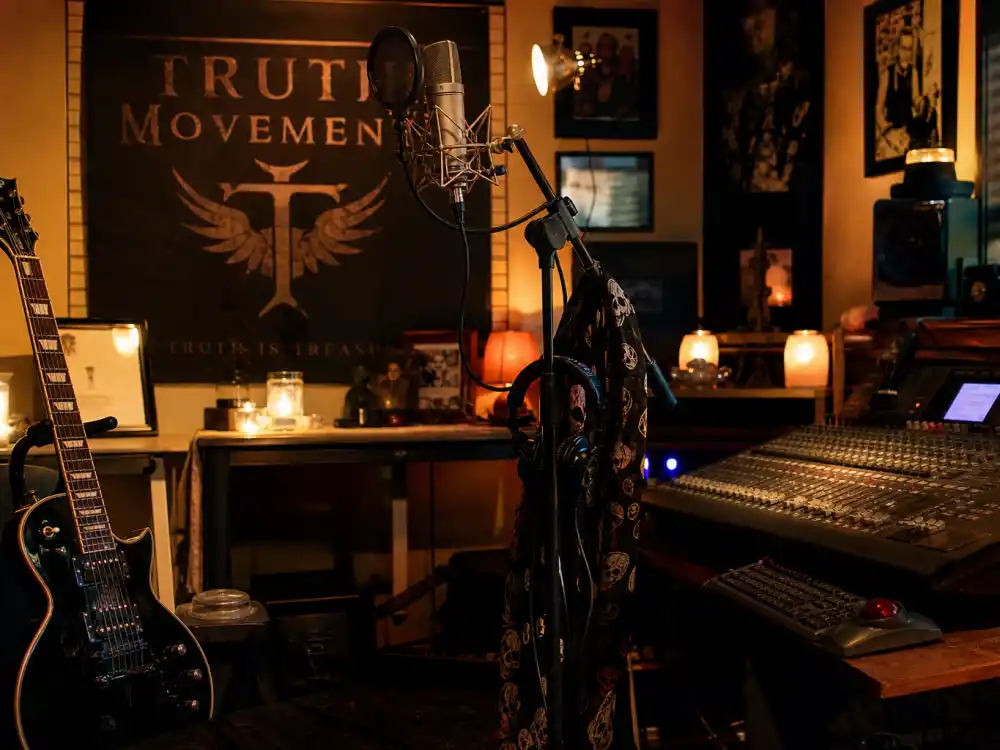 Home recording studio with guitar and microphones for Corey Feldman music career and Truth Movement band