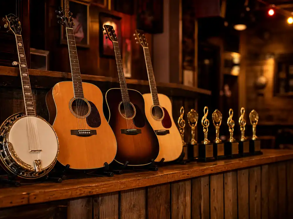 Acoustic guitars and banjo beside golden trophies on a honky-tonk bar evoke wins for country artists with the most Grammys