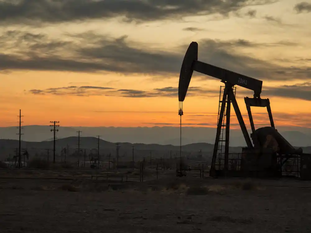 Oil pump jack at desert sunset evoking Daniel Day-Lewis There Will Be Blood era as Daniel Plainview