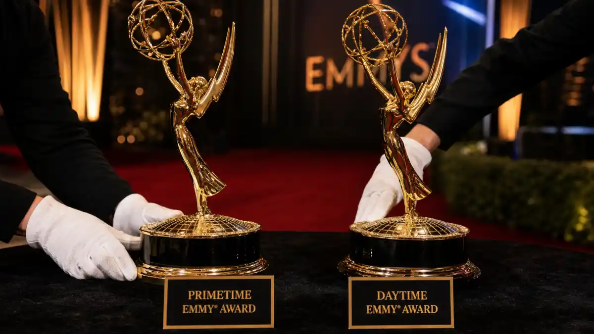 Difference between Primetime and Daytime Emmys — two gold winged statuettes with Primetime and Daytime plaques on velvet at a television awards ceremony