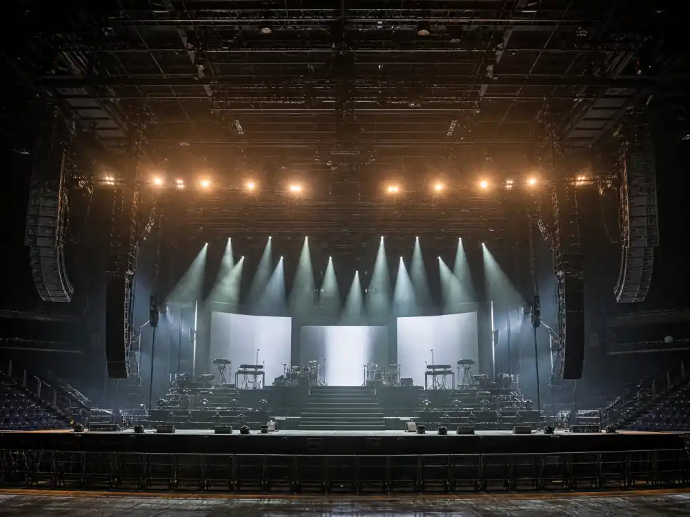 Arena concert stage reflecting Dua Lipa age and birthday 2026 touring milestones from debut album era to stadium-scale headline runs in her late twenties