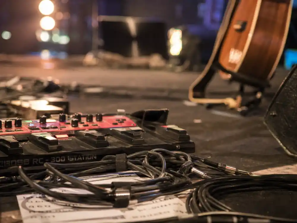 Loop pedal and guitar cables on stage reflecting Ed Sheeran age and birthday 2026 signature one-man live show style from teenage busking through arena world tours