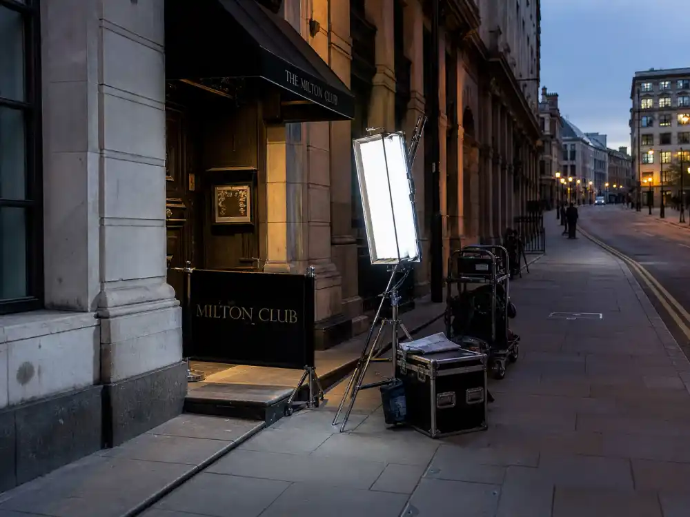 Contemporary city street at dusk with production lights represents streaming-era Emmy best drama winners by year including Shōgun and The Pitt