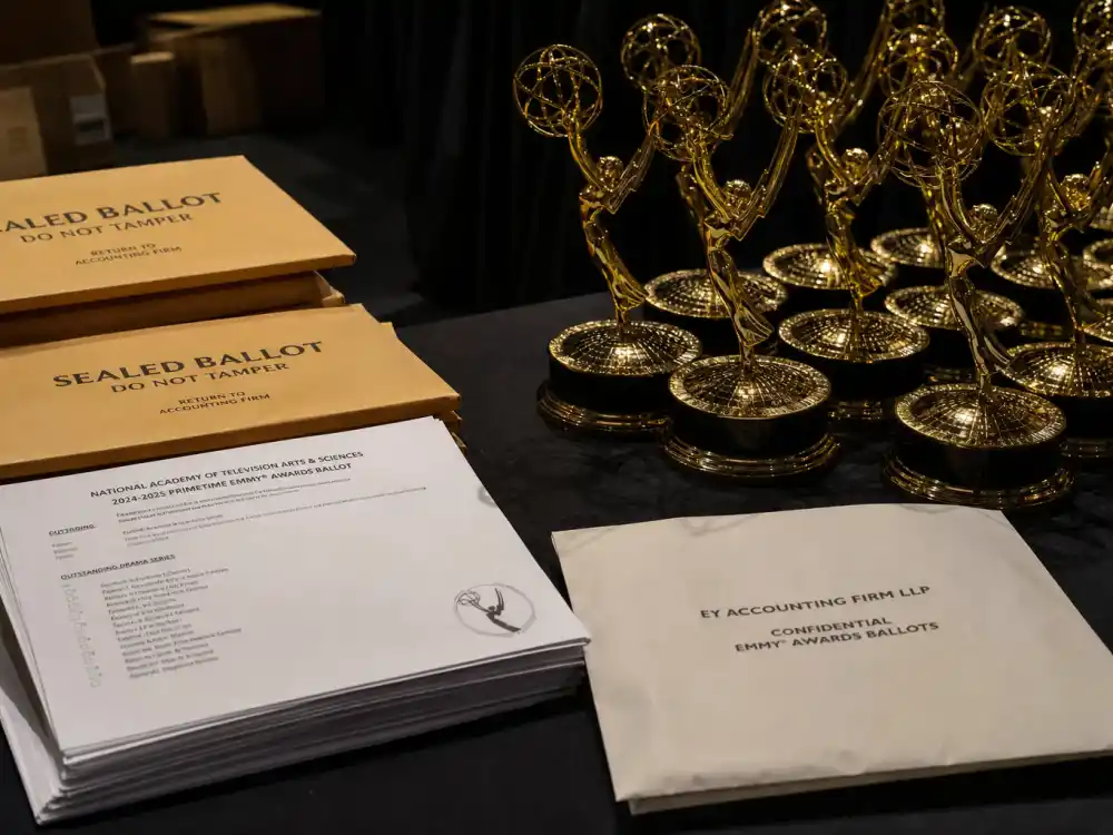 Sealed voting envelopes beside golden television trophies illustrate how Television Academy members choose Emmy best drama winners by year