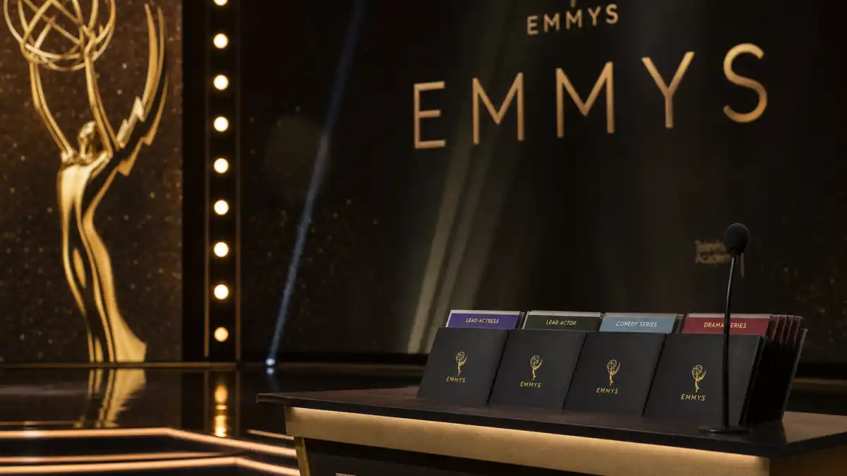 Emmy categories explained guide — Primetime Emmy stage podium with category envelopes for Drama, Comedy, Lead Actor, and Lead Actress under golden ceremony lighting