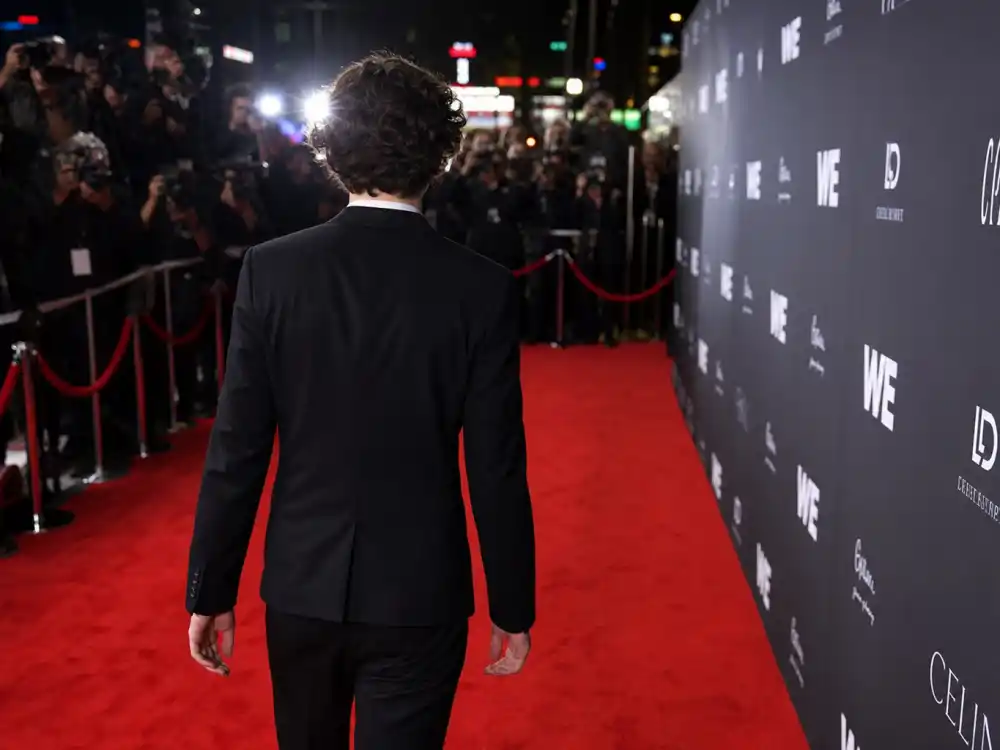 Hollywood red carpet premiere from behind for famous celebrity children who are famous now cross-generational fame debut editorial without identifiable faces