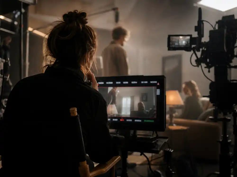 Anonymous filmmaker reviewing footage on a film-set monitor tied to female directors who won best director Oscar craft milestones