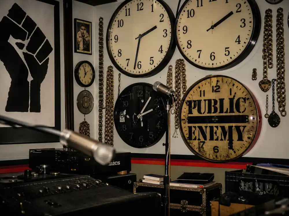 Public Enemy clock props in a recording studio for where is Flavor Flav now hip-hop roots