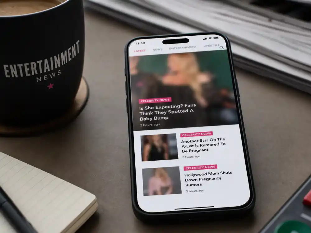 Smartphone with blurred tabloid feed for Florence Pugh pregnancy rumors addressed social media speculation desk