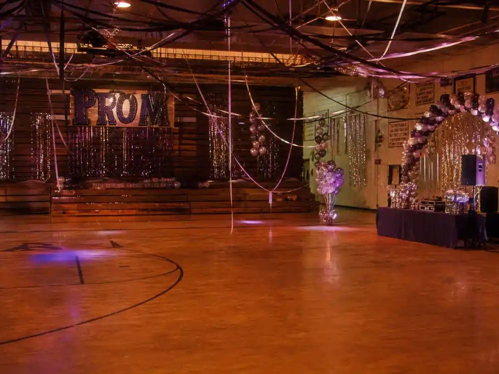 A decorated high school prom gym evoking the She's All That era when Freddie Prinze Jr became a teen-movie star
