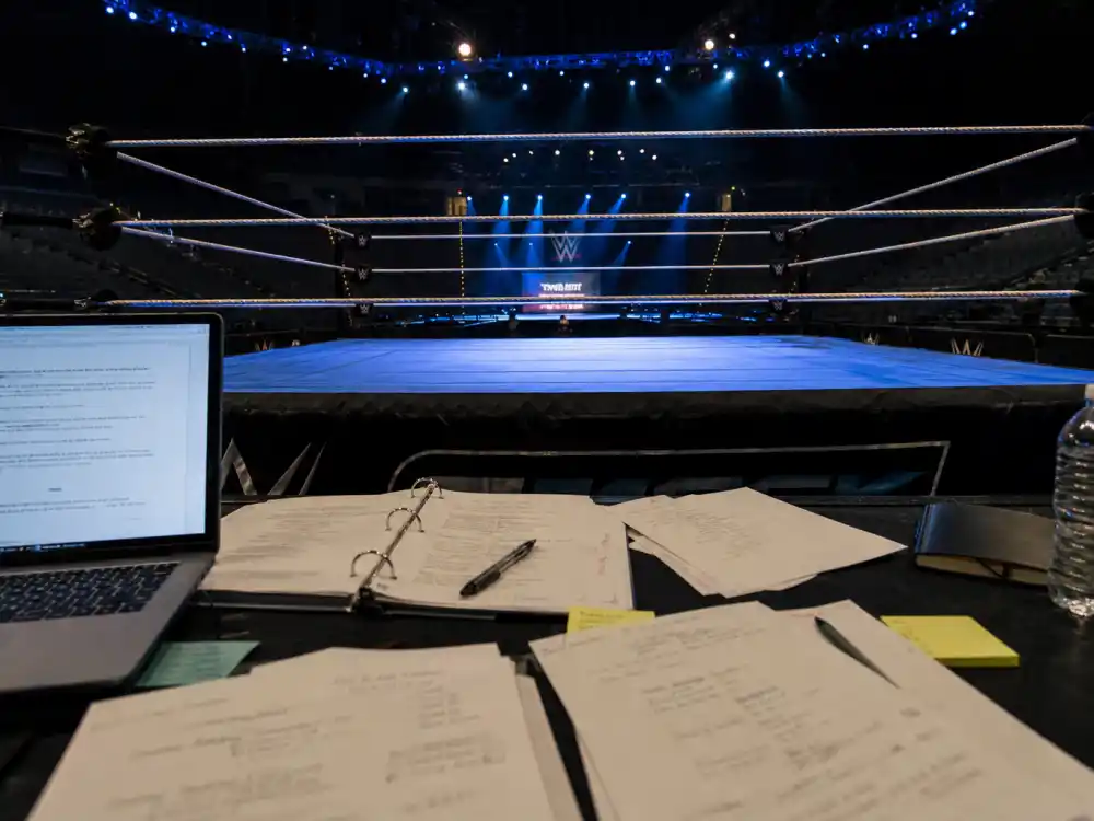 An empty wrestling ring under arena lights representing Freddie Prinze Jr WWE writing and producing work