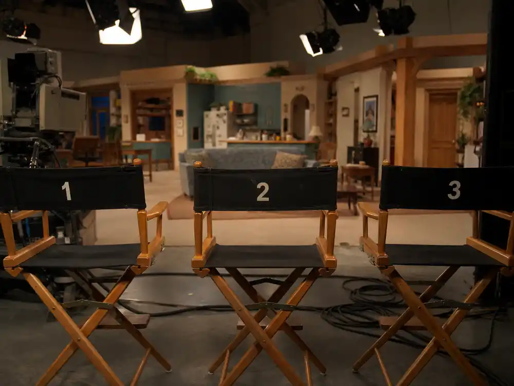 1990s TV studio soundstage with director chairs for the Full House cast where are they now peak TGIF era