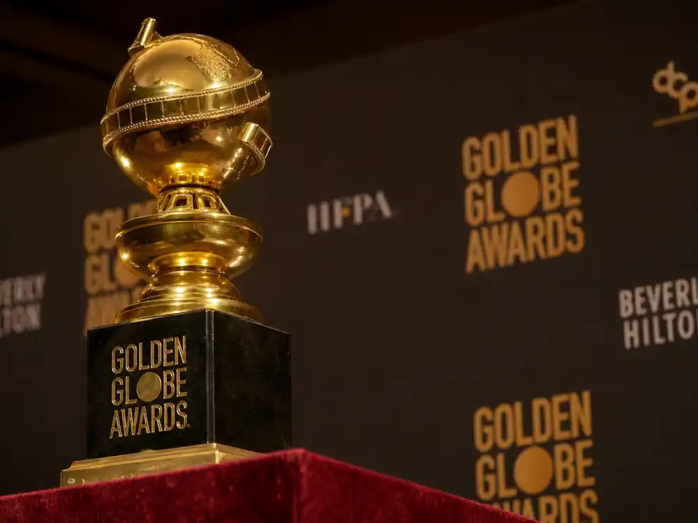 Golden Globe statuette on velvet pedestal symbolizing every honoree on the Golden Globes 2026 winners full list at Beverly Hilton