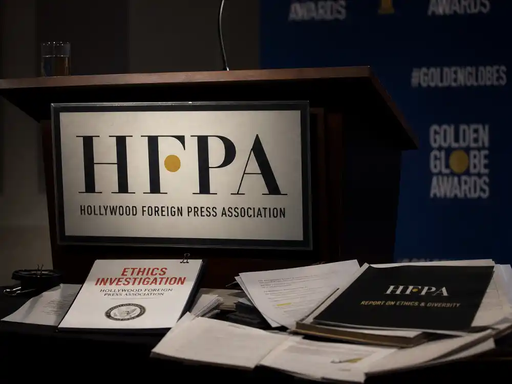 HFPA ethics scandal documents on press podium illustrate Golden Globes biggest controversies history after 2021 Los Angeles Times investigation