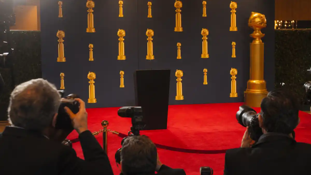 Golden Globes winners list all time — press wall backdrop with golden globe statuette and red carpet at Beverly Hilton awards ceremony