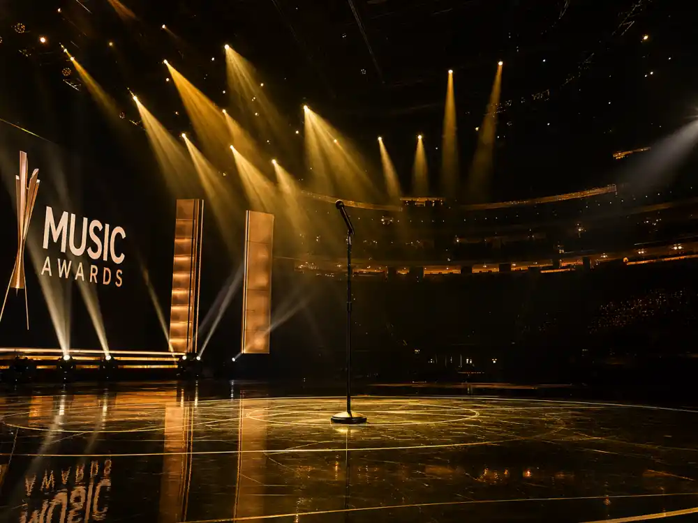 Arena stage spotlights and microphone evoke the ceremony nights that decide the most Grammy awards won by an artist