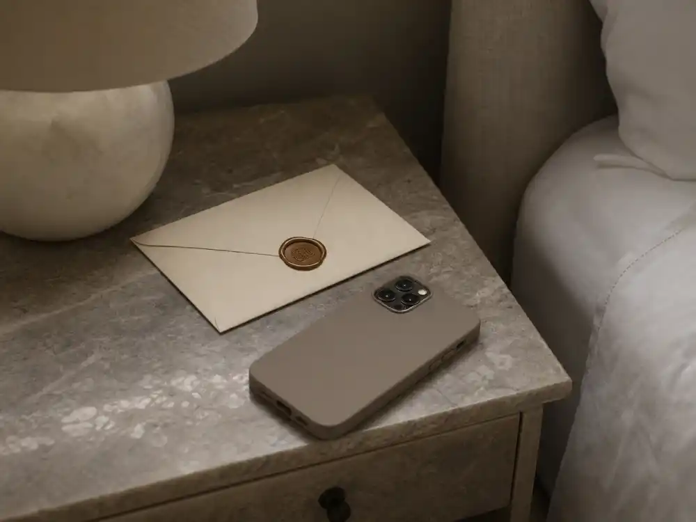Sealed envelope and phone face-down symbolizing six months of secrecy in Hailey Bieber pregnancy announcement timeline before May reveal