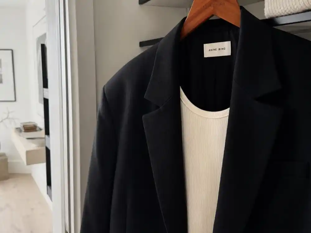 Oversized black blazer over cream ribbed tank central to Hailey Bieber street style looks blazer uniform
