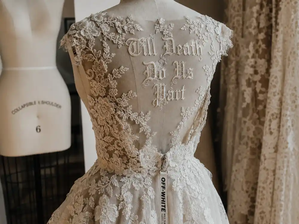 Backless lace panel with Till Death Do Us Part gothic embroidery central to Hailey Bieber wedding dress Off-White Virgil Abloh design signature