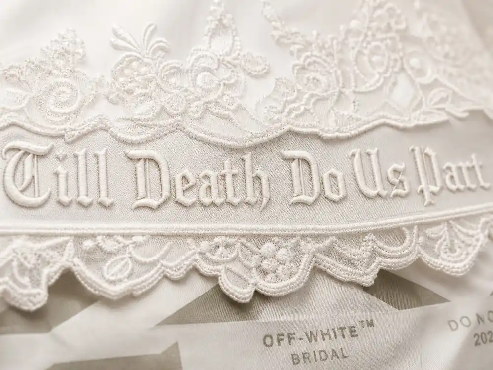 Till Death Do Us Part veil embroidery and Off-White industrial tag detail on Hailey Bieber wedding dress Off-White couture close-up