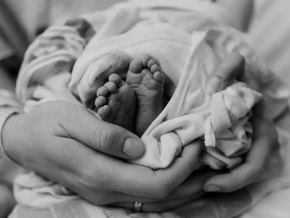 Black and white hospital hands cradling newborn for Halsey baby announcement 2025 birth chapter — Ender Ridley Aydin July 2021 reveal