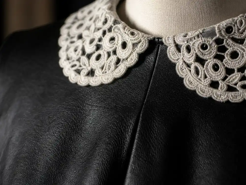 Black leather and white lace Peter Pan collar construction defining Harry Styles Gucci dress Grammy history textile and silhouette signature
