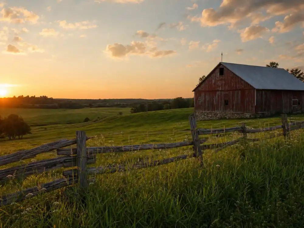 A quiet rural farm at golden hour, like the countryside where Hayden Christensen spent years away from Hollywood