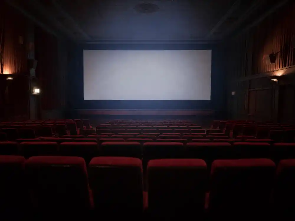 A dim, empty movie theater reflecting the early backlash Hayden Christensen faced over the Star Wars prequels
