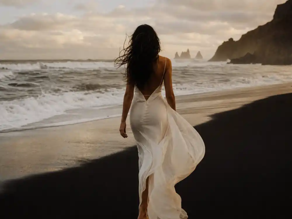 Windy coastal beach scene evoking Helena Christensen Wicked Game music video era