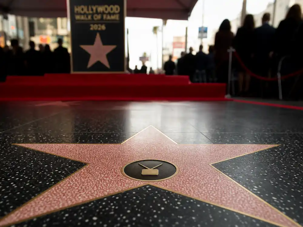 Television category honorees on the Hollywood Walk of Fame 2026 honorees list — TV emblem stars at unveiling ceremony podium on the boulevard