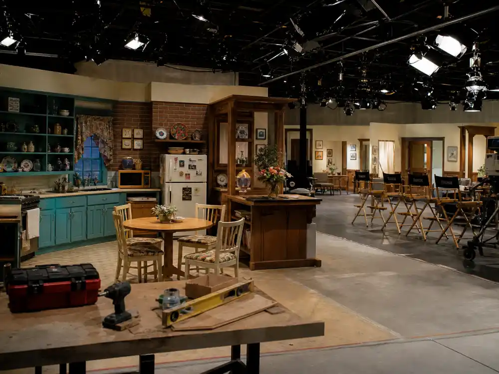 Empty 1990s sitcom soundstage with studio lights for the Home Improvement cast where are they now behind-the-scenes era