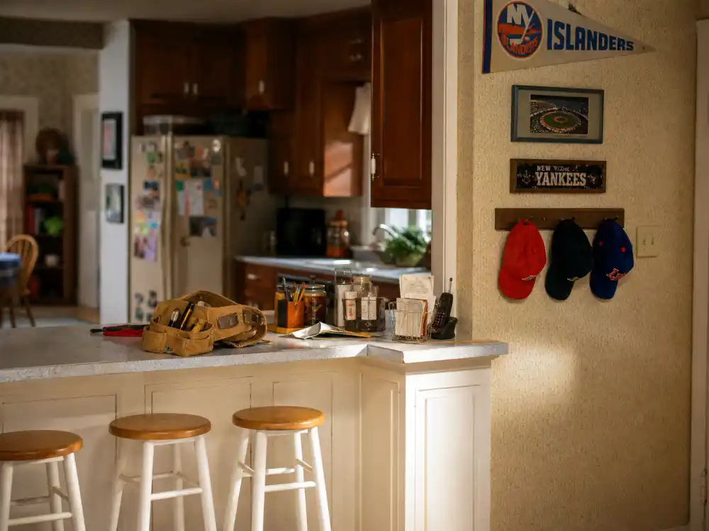 Warm suburban family kitchen with tool belt and baseball caps evoking the Home Improvement cast where are they now Taylor household