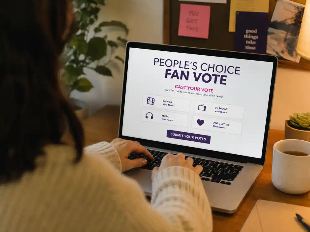 Anonymous fan submitting online ballot for how are Peoples Choice Awards winners chosen — laptop vote confirmation on home office desk