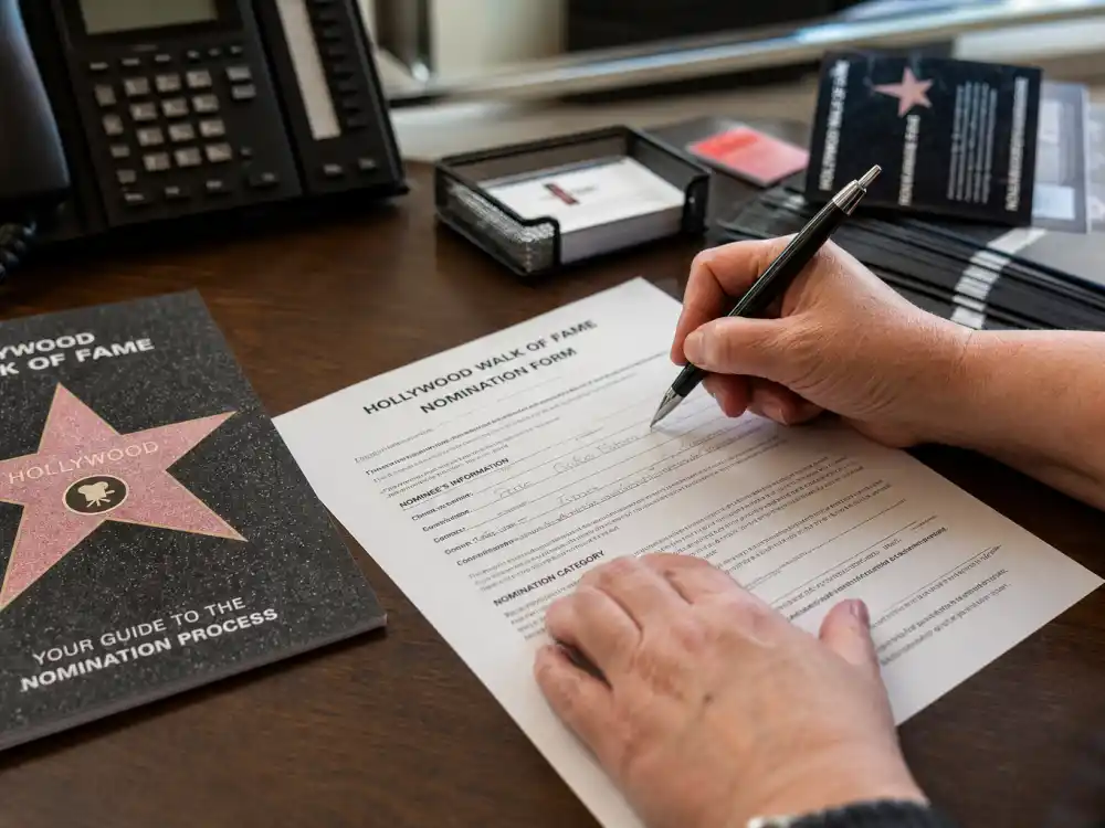 Official Hollywood Walk of Fame nomination paperwork on a desk for how do celebrities get a Hollywood Walk of Fame star application process
