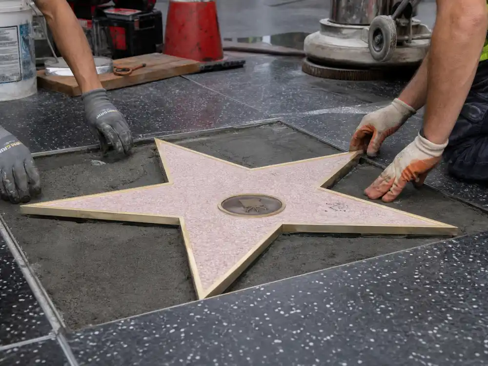 Walk of Fame star installation on Hollywood Boulevard sidewalk — how much does a Walk of Fame star cost includes professional terrazzo placement