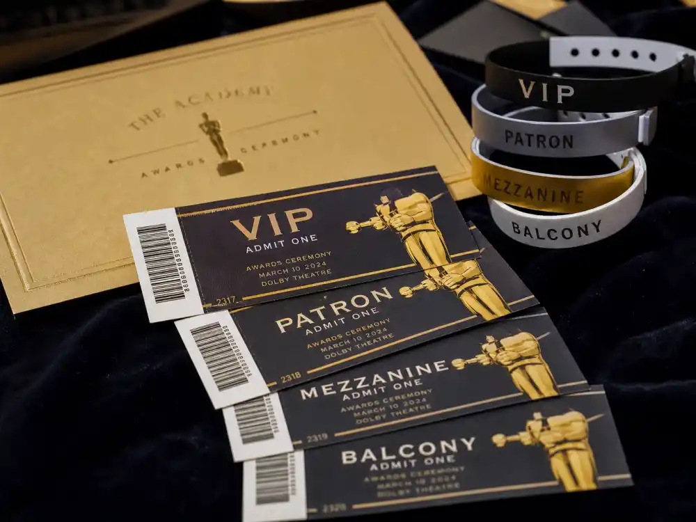 Formal awards ceremony tickets and golden invitation envelopes — how much does it cost to attend award shows when Oscar seats are invite-only