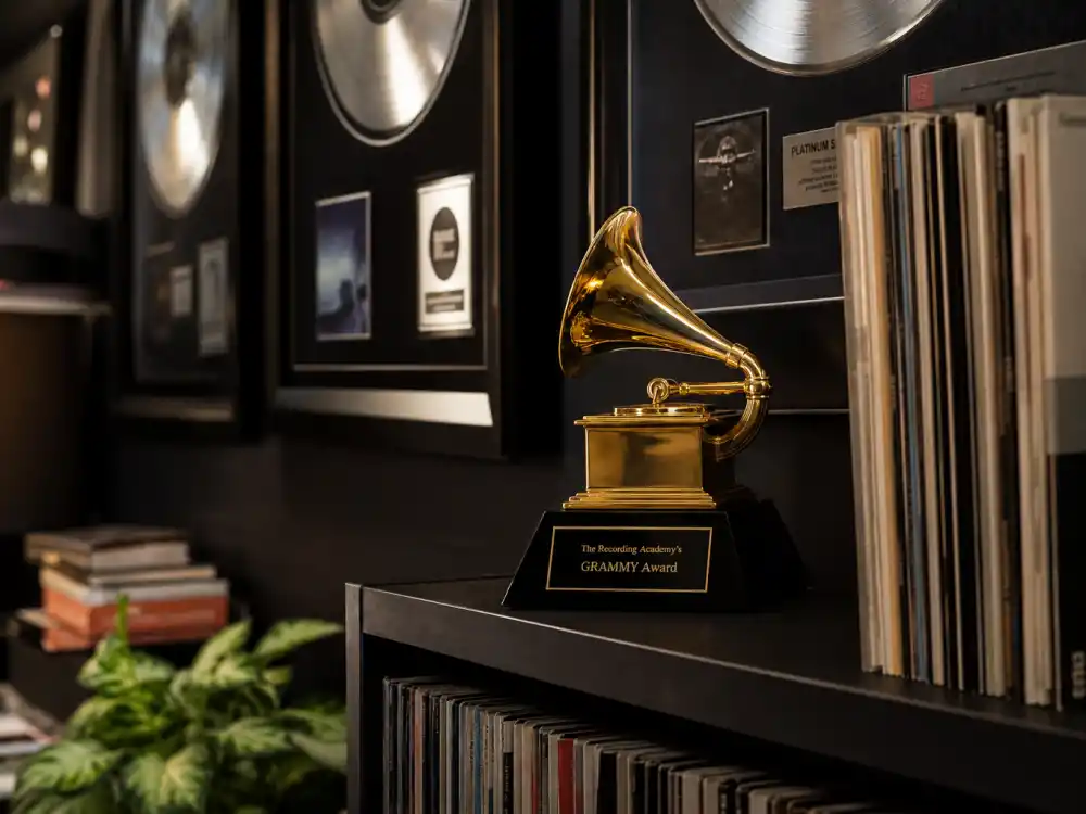 Music industry award trophy display reflecting how old is Cardi B at her industry peak — chart-topping albums and Grammy-winning milestones in her twenties