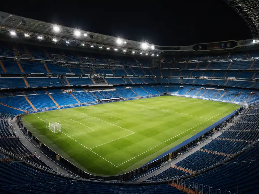 Soccer stadium interior reflecting how old is Cristiano Ronaldo at industry peak — Champions League runs and record-setting longevity across a twenty-plus-year professional career