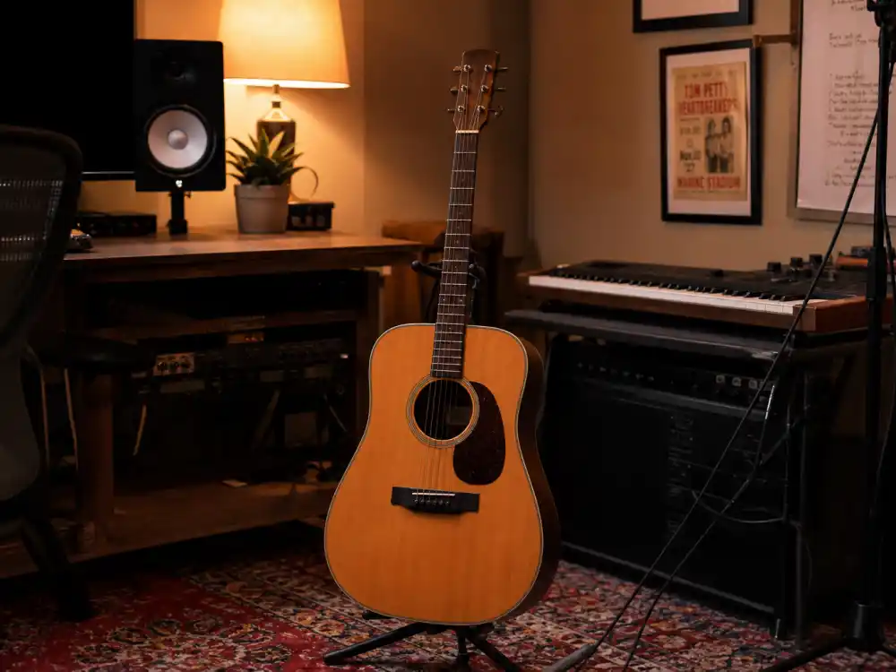 Acoustic guitar on a stand in a home studio reflecting how old is Ed Sheeran early career when Suffolk pub gigs and loop-pedal shows launched his rise
