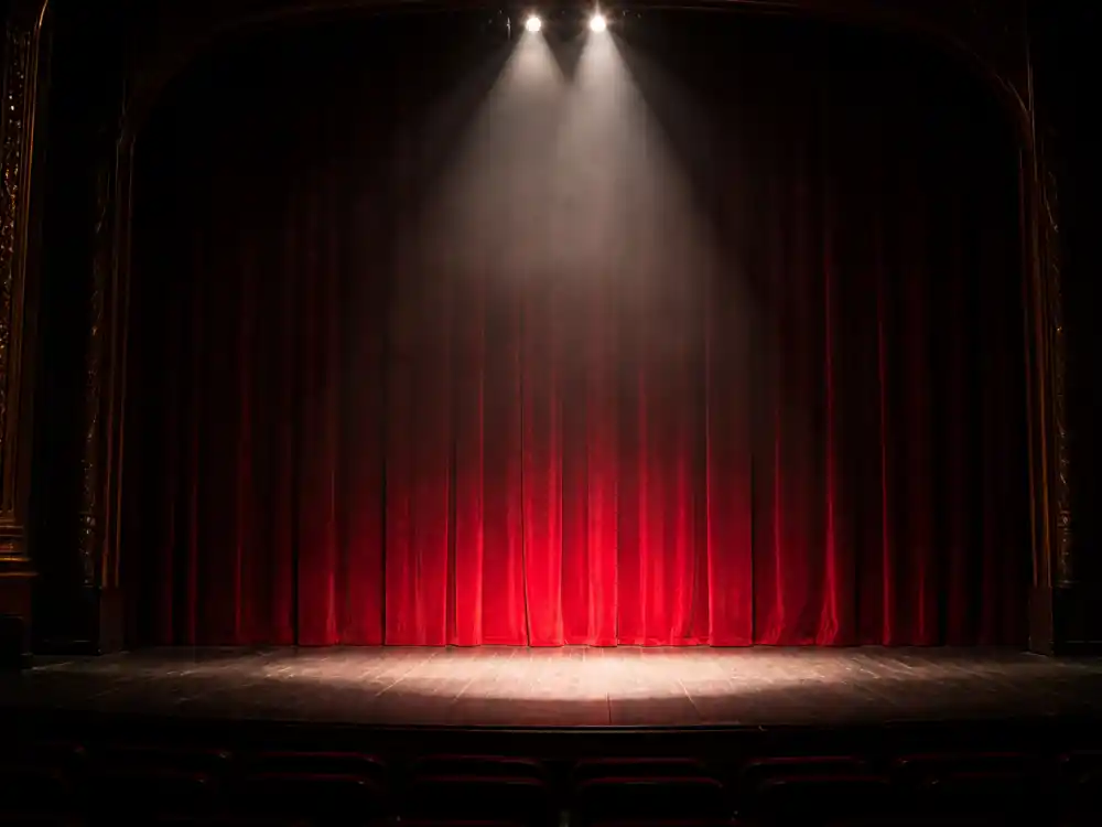 Theater stage spotlight reflecting how old is Emily Blunt career arc from London drama training to Golden Globe-winning Hollywood stardom