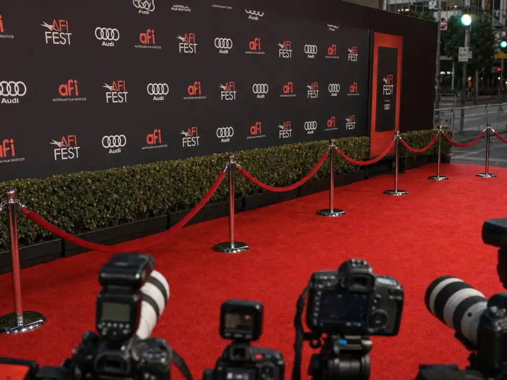 Red carpet premiere display reflecting how old is Emma Stone at industry peak — Oscar-winning milestones and blockbuster franchise dominance in her twenties and thirties