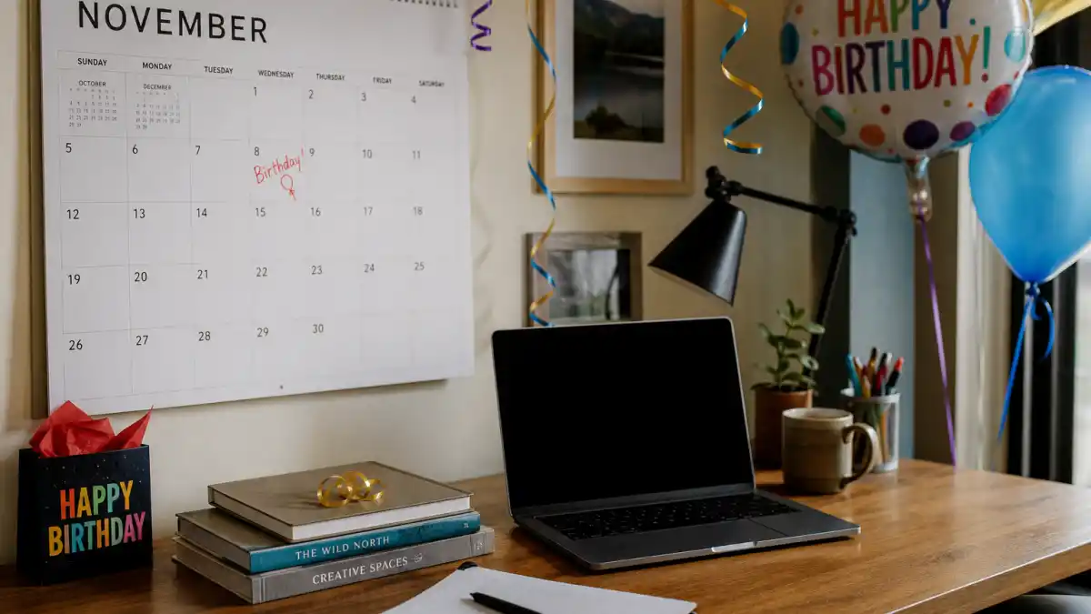 How old is Emma Stone — desk calendar open to November with birthday decorations marking her Scorpio birth date