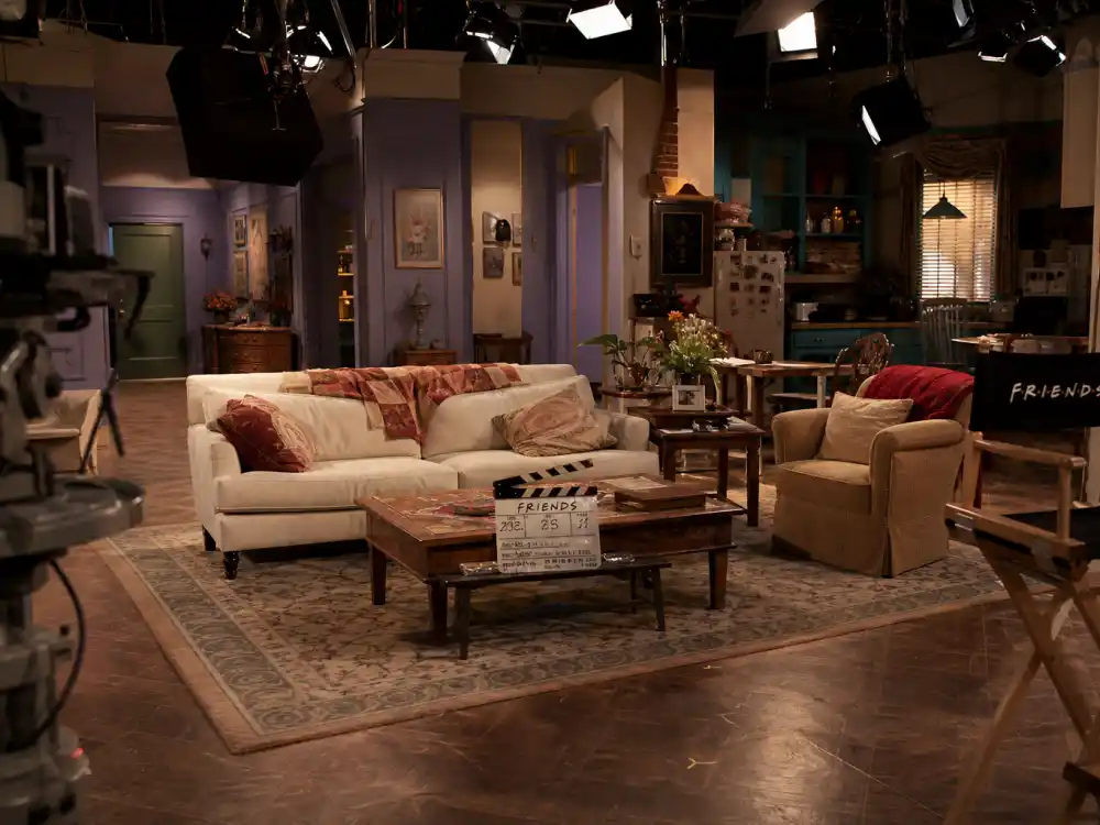 Television studio set reflecting how old is Jennifer Aniston career arc from sitcom breakout to Emmy-winning drama and blockbuster film stardom