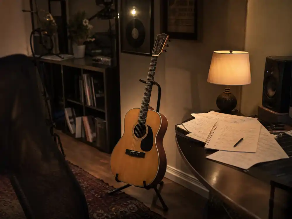 Acoustic guitar on a stand in a home studio reflecting how old is Justin Bieber early career when YouTube covers launched his global rise